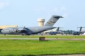 A C-17A Globemaster III of the 911th Airlift Wing about to exit the runway with its sister ships on the flight-line at Pittsburgh International Airport ARS