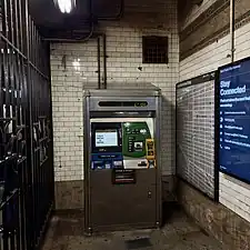 A MVM fronting the original tiled wall at the northbound fare control area