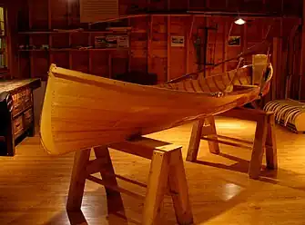 An Adirondack guideboat elevated on sawhorses