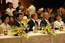 Kwon and Roh Moo-hyun at the 2006 APEC gala dinner with President Vladimir Putin of Russia (centre) and George W. Bush and Laura Bush (right)