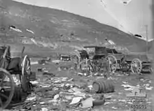 Two soldiers in background near staff car