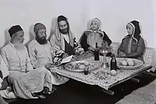 Jewish family reading the psalms after lunch on the Sabbath