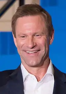 A photograph of Aaron Eckhart