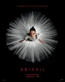 A young girl in a blood-stained white ballerina outfit looks up.