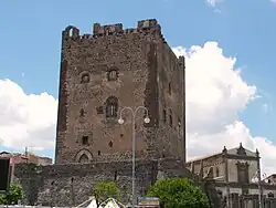 Large, square stone building in a town