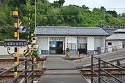 Exterior of station building showing level crossing