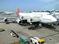 Two Aircraft Catering Vehicles serving an aircraft