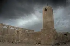 Al Hussein Mosque in Al Jumail overlooked by dark clouds.