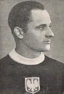 A black and white photo of a young man looking away from the camera and wearing a Polish national ice hockey team sweater