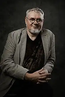 photo portrait of bearded man, seated