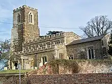 A photograph of All Saints Church taken from Sutton High Street