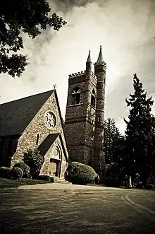 Exterior photograph of All Souls Chapel featuring ornate gothic architecture made of Medina Sandstone and the chapel bell tower.