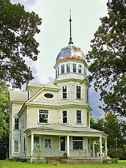 A metal bell roof on the Almond A. White House in the United States