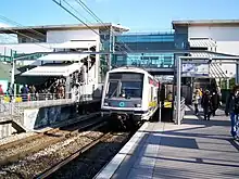 A train (MI2N) arriving at the station  (towards Paris)