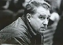 Black and white photo of a middle-aged man wearing a dark winter jacket