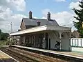 Closer view of the main station building and level crossing beyond.