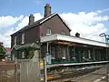 The substantial former station house, looking north from the level crossing.