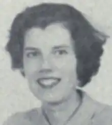 A smiling young white woman with short dark hair