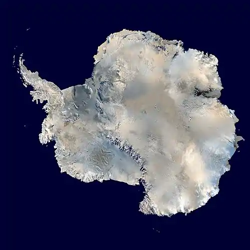 Satellite photograph of a large white ice cap in a dark blue ocean