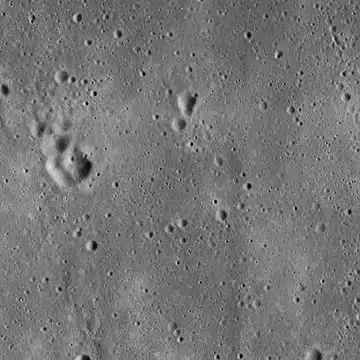 Lunar Orbiter 5 image from 1967, cropped to show the vicinity of the landing site of Apollo 11, used in mission planning.  The image is centered precisely on a small crater called West crater (190 m in diameter), and the lunar module Eagle touched down about 550 m west of West Crater. The area shown is approximately 25 km × 25 km across.