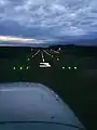 Dusk approach into runway 3 at Minute Man Airfield in a Cessna 172 with the runway lights visible