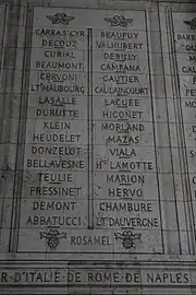 Photograph shows two columns of French names etched in stone.