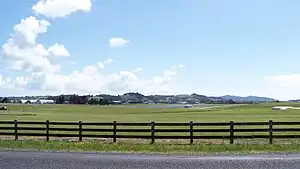 View of Ardmore Airport and surrounding farmland, backed by the Hunua Ranges.