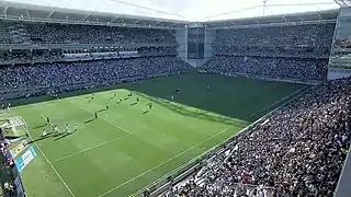 Stadium interior with supporters, photographed from one of its corners