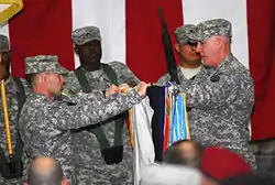 A group of soldiers unrolls a flag