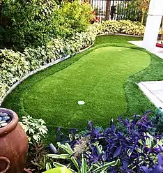 A backyard putting green created using artificial grass