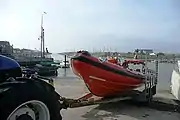 The Littlehampton Atlantic 75-class lifeboat Blue Peter 1 (B-779) being retrieved by the stations TC45 tractor in its launch cradle on the slipway outside the lifeboat station at Fishermen’s Quay on the banks of the River Arun.