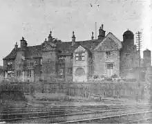 Railway in foreground, an old brick built building in the background