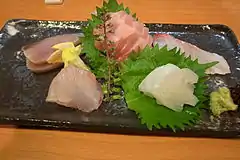 Green shiso leaf used to hold sashimi