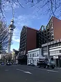 Auckland City Mission's HomeGround building, seen with St Matthew's church and the Sky Tower, 2022.