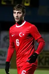 Man in red sports clothing wearing gloves