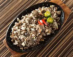 Sisig, usually served in scorching metal plates