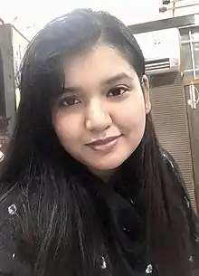 Headshot of a woman with long black hair