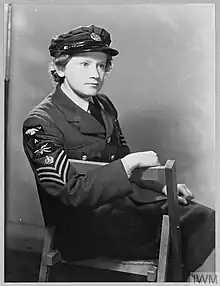 Woman sat on a chair, wearing the uniform of the Women's Auxiliary Air Force