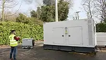 An operator controlling a resistive 200kW Avtron load bank being used to test a diesel generator.