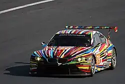 The Jeff Koons-designed BMW Art Car on a race track