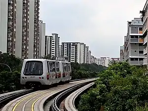 A Bombardier Innovia APM 100 C801A running on the guiderails, in the new SMRT livery.