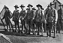 A group of standing men wearing World War I-era military uniforms