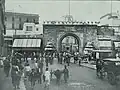 The gate surrounded by shops in 1895