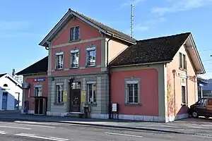 Three-story building with gabled roof and two-story wings