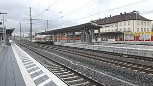 Red-and-white railcar at island platform