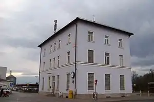 Square three-story building with hipped roof