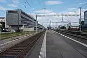 The station looking east, with Glattalbahn tracks on grassed reservation to left