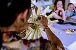 A Balinese woman teaching a class on how to make canang sari offerings.