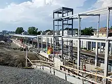 A railway platform under construction in an urban area