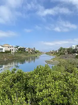 Lemonade berry, closed viewing deck, long body of water between houses on either side